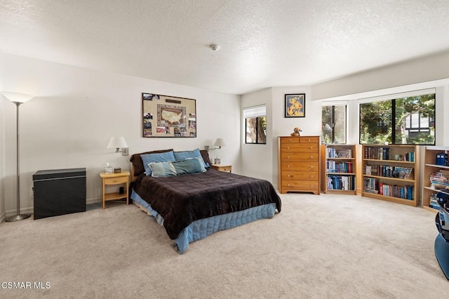 carpeted bedroom featuring a textured ceiling