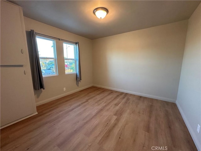 spare room featuring light hardwood / wood-style flooring