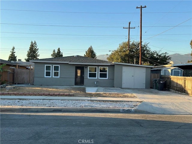 view of front of property featuring a shed