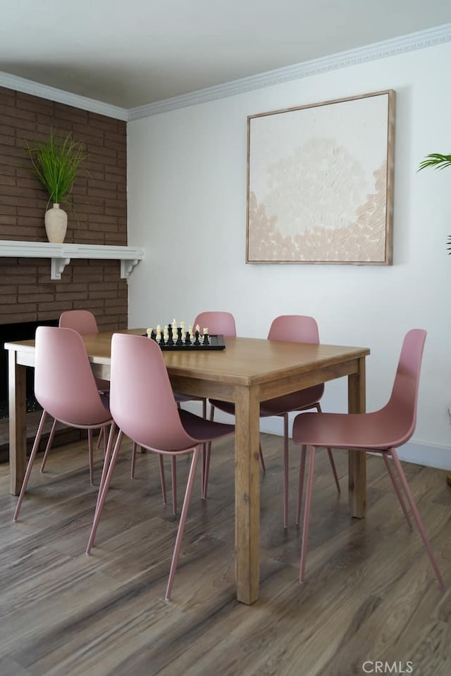 dining room with crown molding and hardwood / wood-style floors