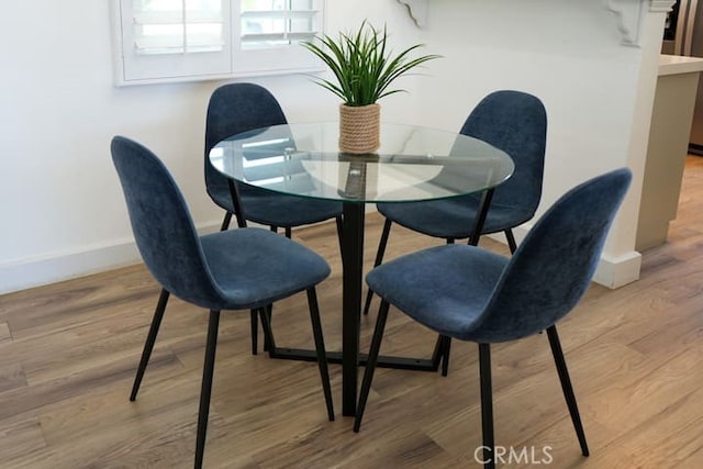 dining space with light wood-type flooring