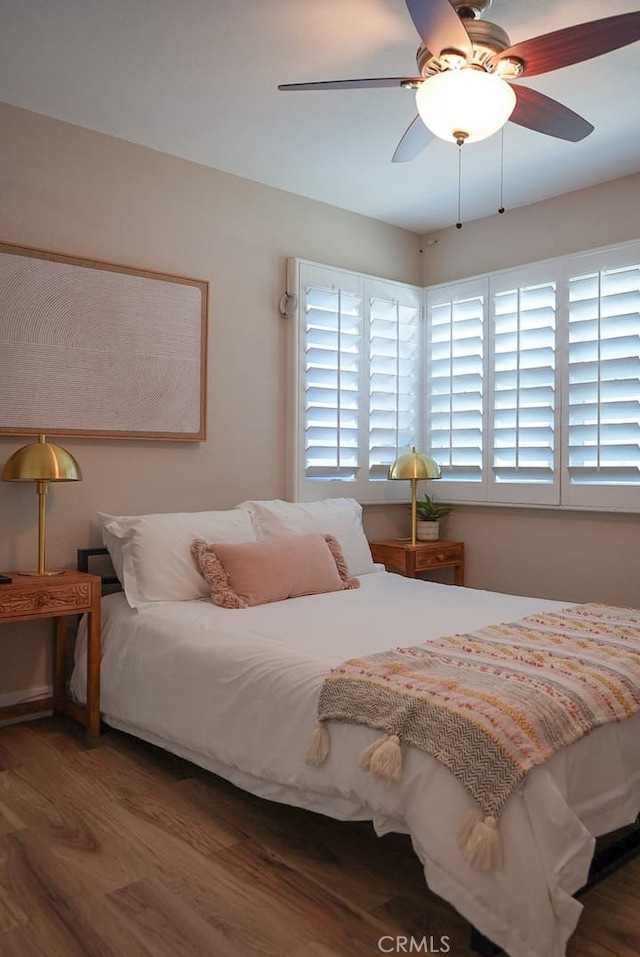 bedroom featuring dark hardwood / wood-style floors and ceiling fan