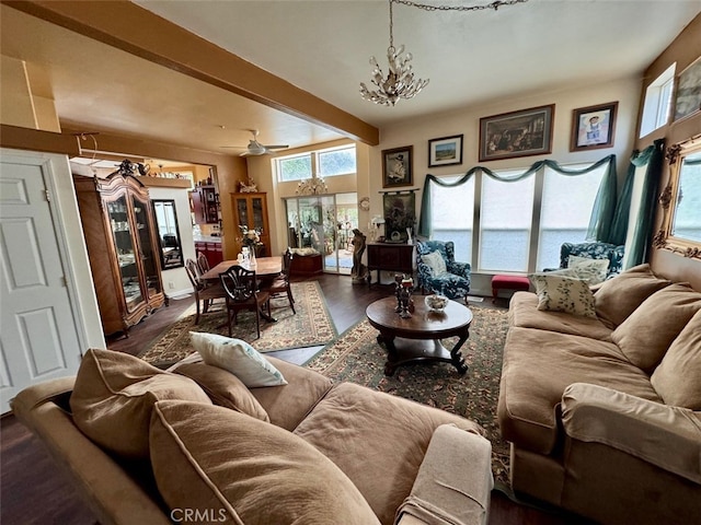 living room featuring beamed ceiling, ceiling fan with notable chandelier, and dark hardwood / wood-style floors