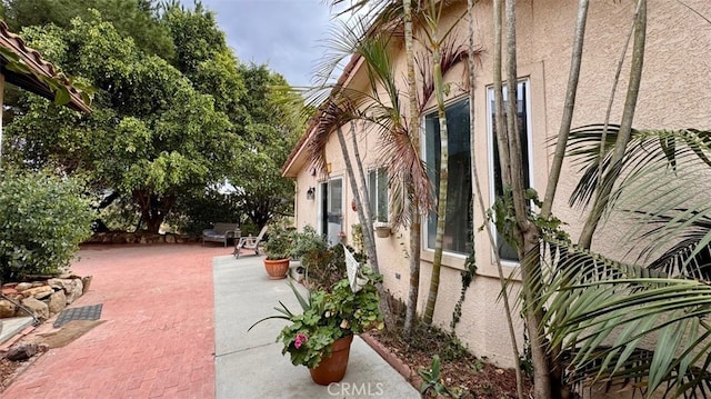 view of property exterior with a patio