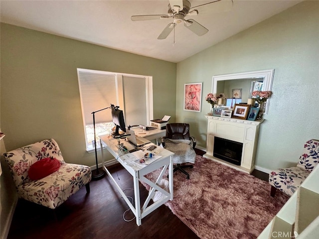 office space featuring ceiling fan, hardwood / wood-style floors, and vaulted ceiling