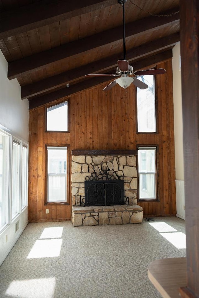 unfurnished living room with carpet flooring, wood walls, and wood ceiling