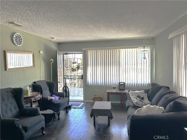 living room featuring hardwood / wood-style flooring and a textured ceiling