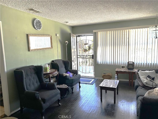 living room featuring wood-type flooring and a textured ceiling