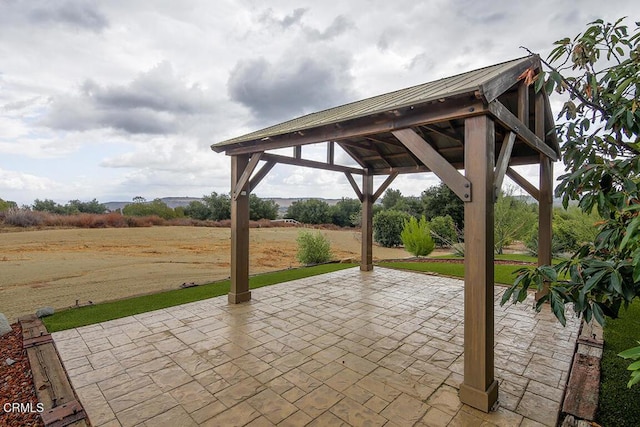 view of patio with a gazebo and a rural view