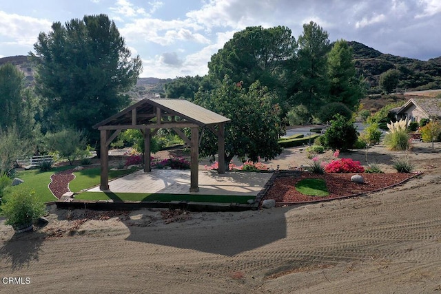 view of property's community featuring a mountain view, a gazebo, and a yard