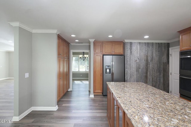 kitchen featuring light stone countertops, dark hardwood / wood-style flooring, stainless steel appliances, and crown molding