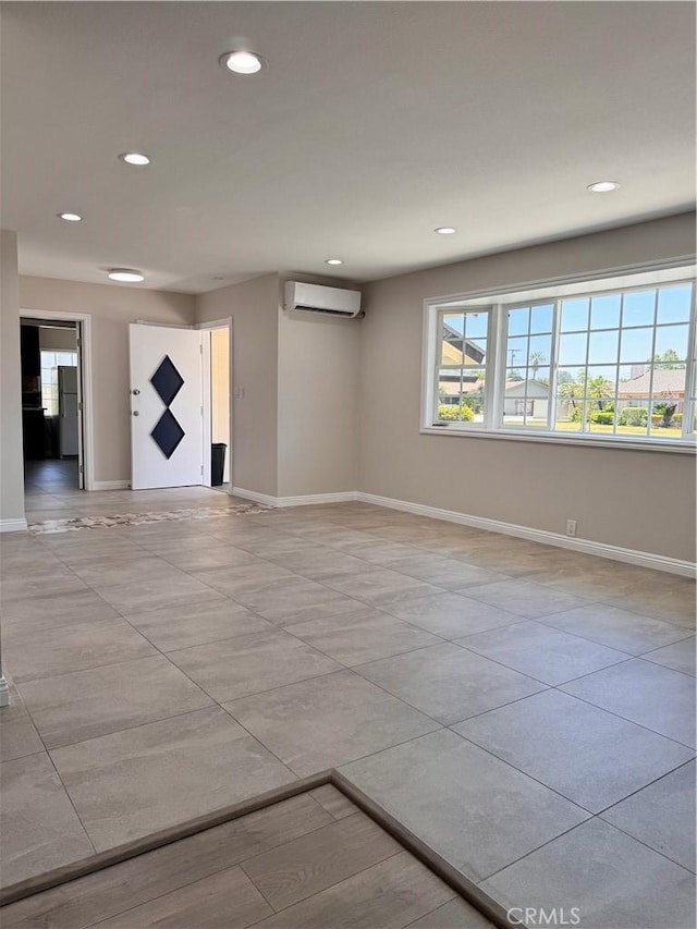 unfurnished room featuring an AC wall unit