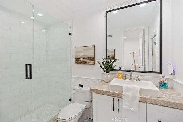 bathroom with a stall shower, toilet, crown molding, vanity, and recessed lighting