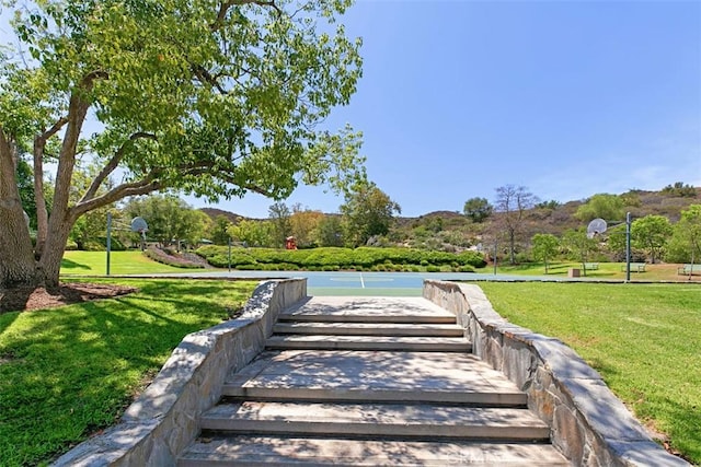 view of home's community featuring a lawn