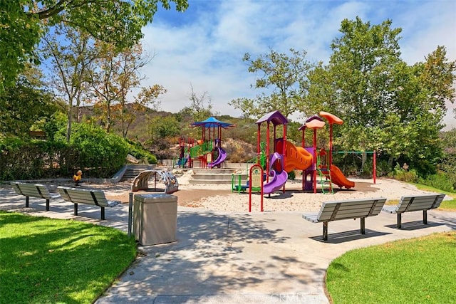 communal playground featuring a lawn