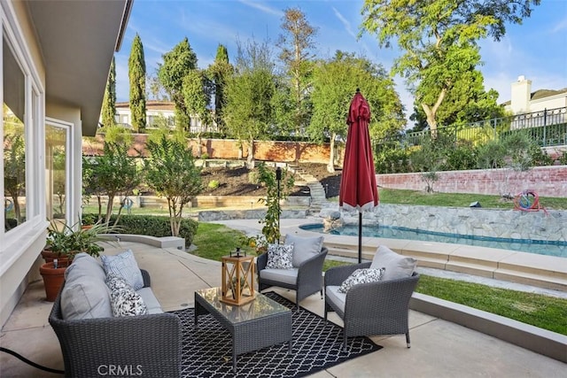 view of patio featuring a fenced backyard and an outdoor living space