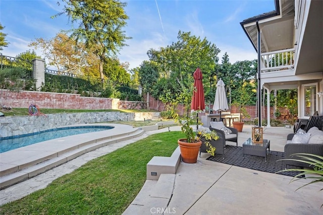 view of patio featuring a fenced backyard, an outdoor living space, and a fenced in pool