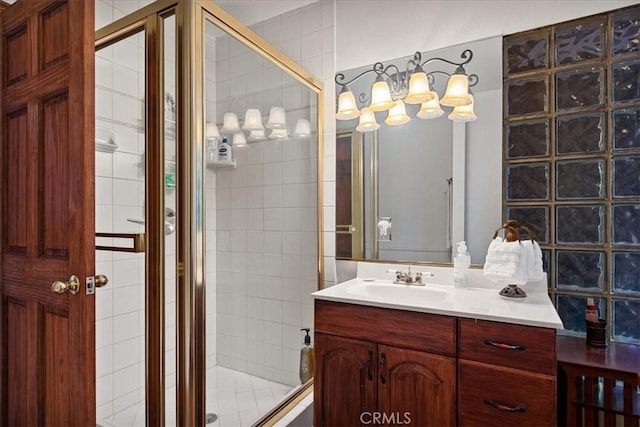 bathroom featuring vanity and a shower with door