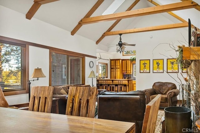 living room with ceiling fan, beam ceiling, and high vaulted ceiling