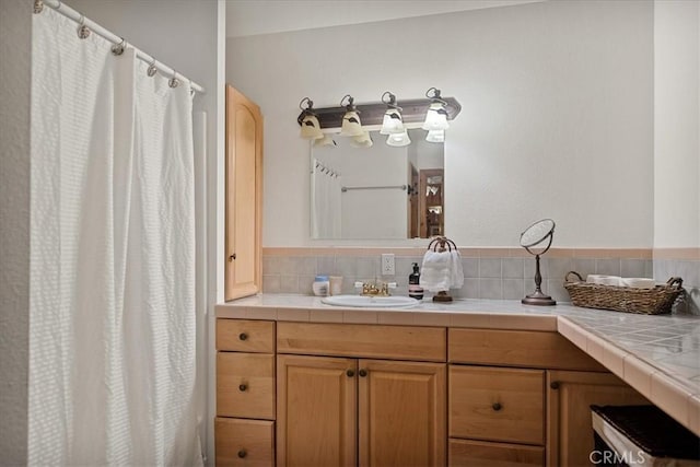 bathroom with decorative backsplash, vanity, and curtained shower