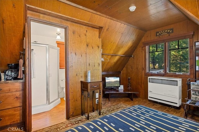 bonus room with dark hardwood / wood-style flooring, heating unit, wood walls, vaulted ceiling, and wood ceiling