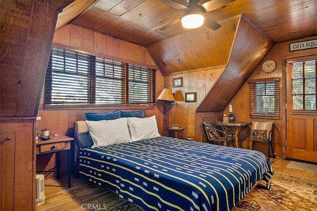 bedroom with ceiling fan, wooden ceiling, wood walls, lofted ceiling, and hardwood / wood-style flooring