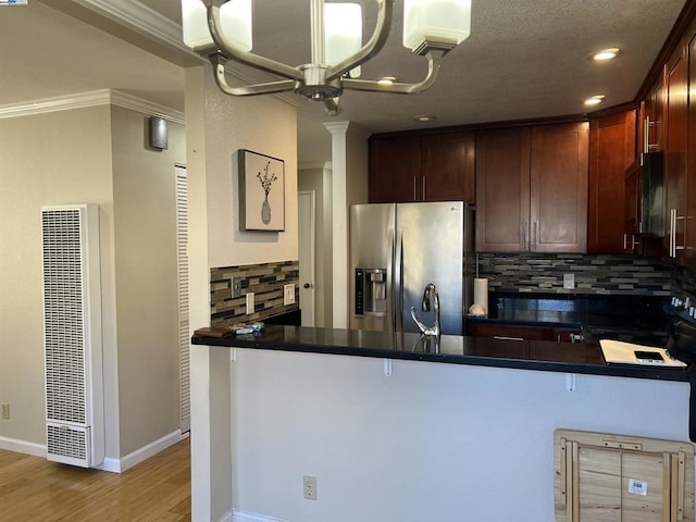 kitchen with stainless steel refrigerator with ice dispenser, ornamental molding, kitchen peninsula, light hardwood / wood-style floors, and decorative backsplash