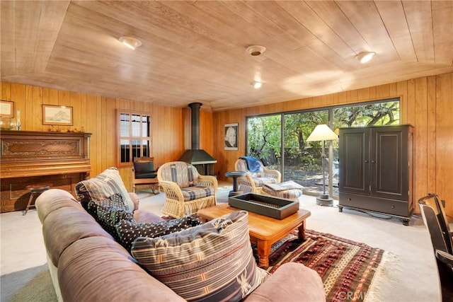 living room with light colored carpet, vaulted ceiling, wooden ceiling, and wood walls