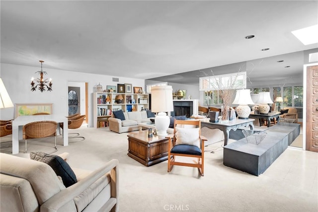 living room featuring light colored carpet and a notable chandelier