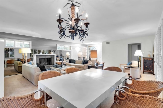 dining room with a tiled fireplace and an inviting chandelier