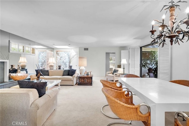 living room featuring light colored carpet and a chandelier