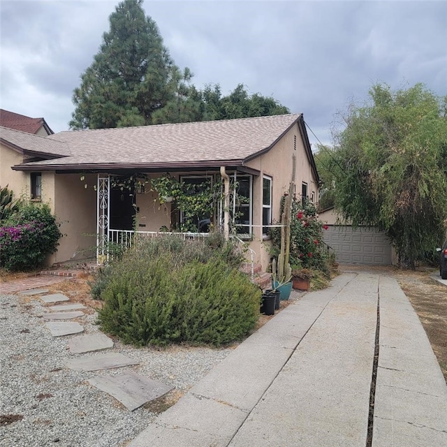 view of front of home with a garage and an outdoor structure