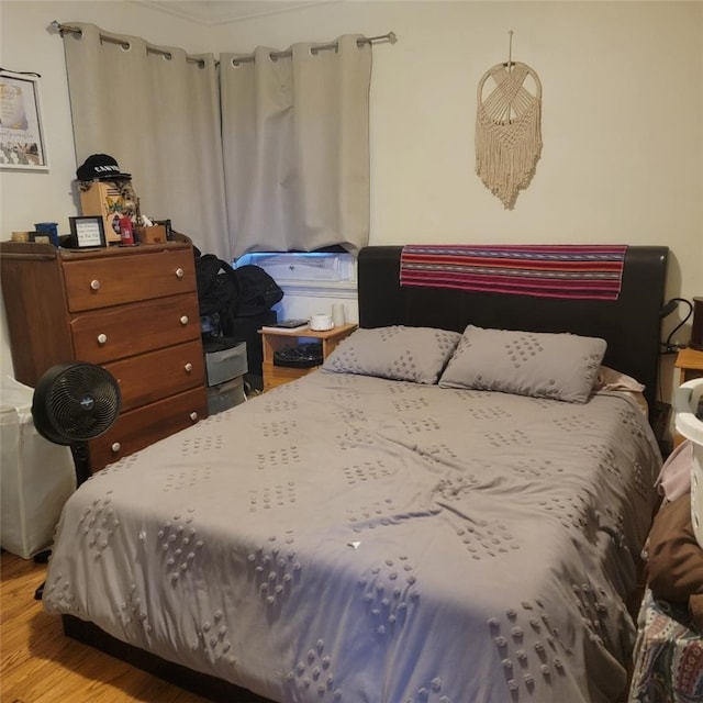 bedroom with hardwood / wood-style floors