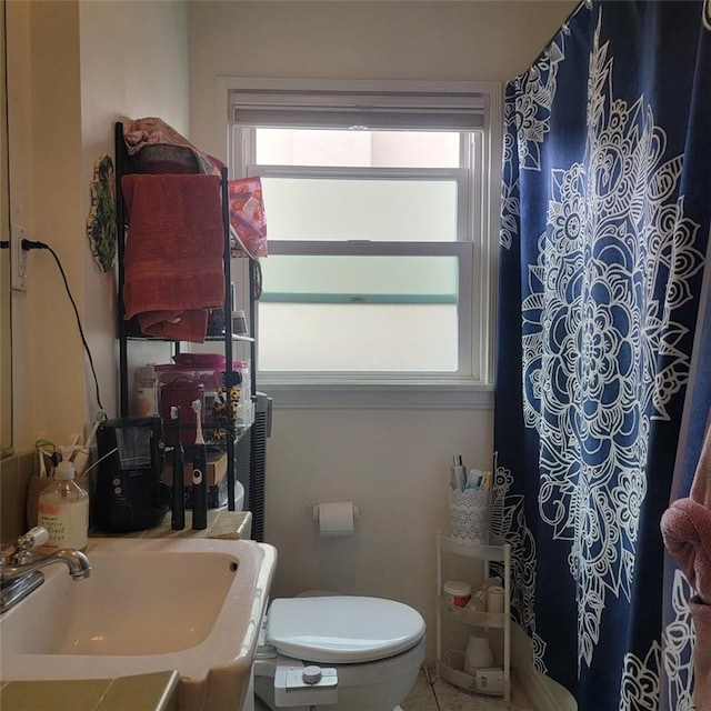 bathroom featuring tile patterned floors, toilet, and sink