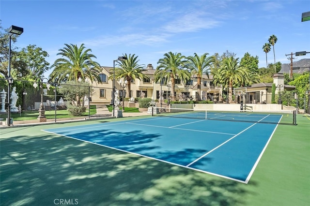 view of tennis court featuring basketball hoop