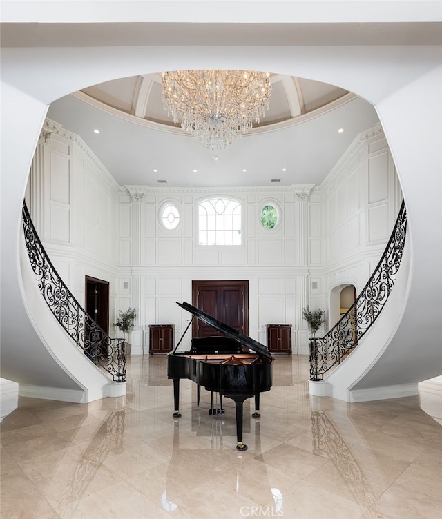 misc room with a high ceiling and an inviting chandelier