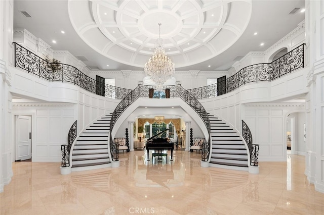 interior space with a towering ceiling and an inviting chandelier