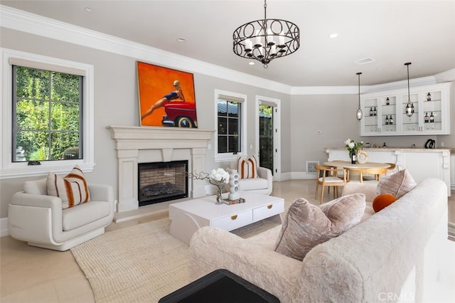 living room featuring crown molding and a notable chandelier