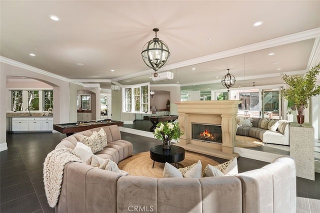 living room with an inviting chandelier, dark hardwood / wood-style flooring, billiards, a wall mounted AC, and ornamental molding