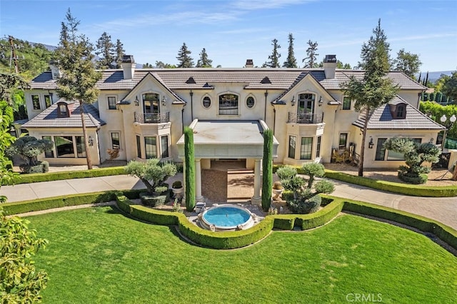 exterior space with a front yard and a balcony