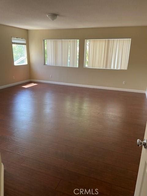 1467 Avila Dr, Perris, CA 92517 - spare room featuring baseboards and dark wood-type flooring