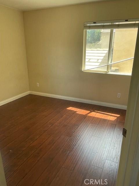 1467 Avila Dr, Perris, CA 92517 - unfurnished room with dark wood-type flooring and baseboards