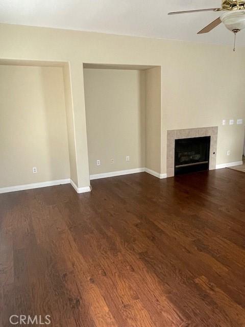 1467 Avila Dr, Perris, CA 92517 - unfurnished living room featuring ceiling fan, wood finished floors, and a tile fireplace