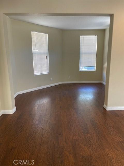 1467 Avila Dr, Perris, CA 92517 - spare room with dark wood-style flooring and baseboards