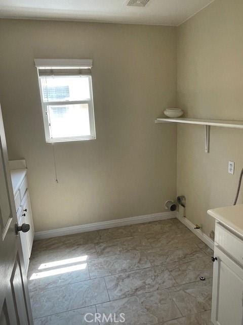 1467 Avila Dr, Perris, CA 92517 - laundry room featuring baseboards and cabinet space