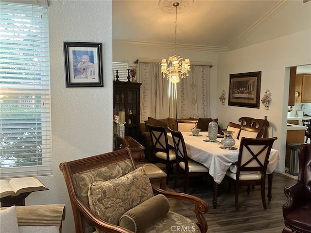 dining space featuring hardwood / wood-style floors, lofted ceiling, crown molding, and a notable chandelier