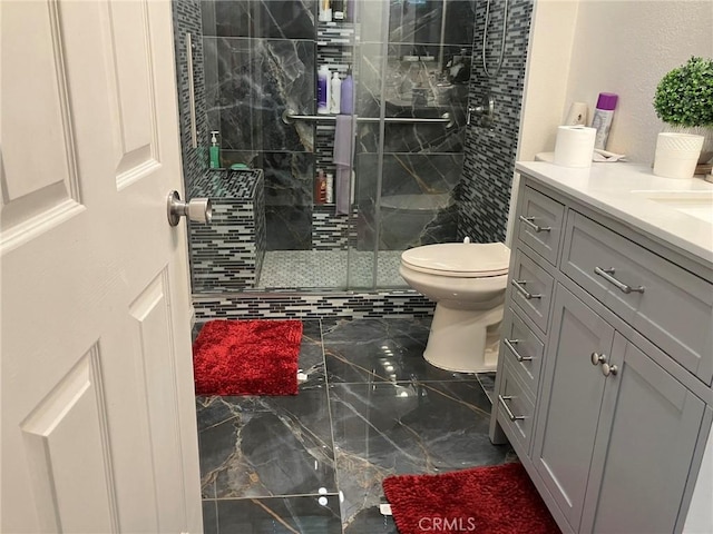 bathroom with vanity, toilet, and walk in shower