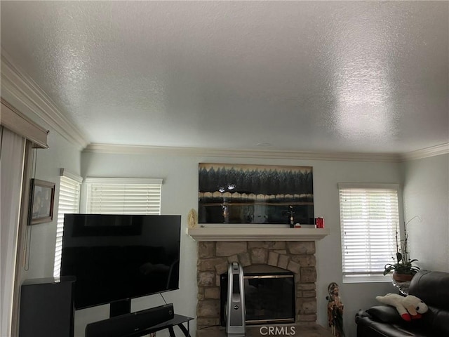 living room with a fireplace, ornamental molding, and a textured ceiling