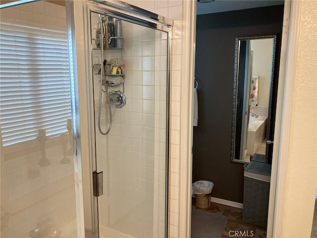 bathroom featuring a shower with door