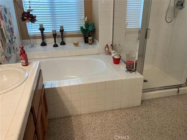 bathroom featuring vanity and separate shower and tub